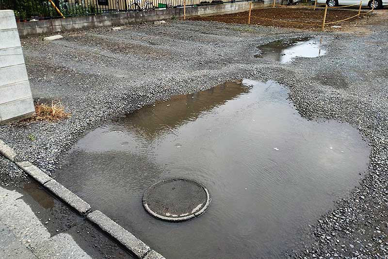 施工前の駐車場の凹凸部分にできた水たまり